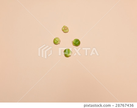 The piles of Brussels sprouts on a pink background 28767436
