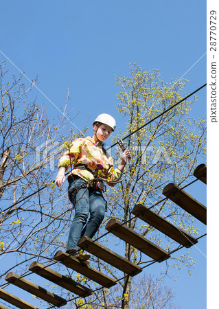 the girl climbs obstacles of rope park the girl climbs obstacles of rope park 28770729