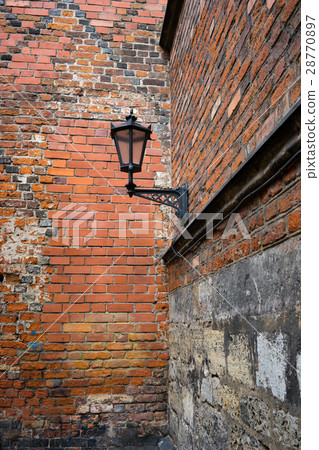 Street lamp on the wall of an old building 28770897