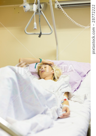 Bedridden female patient recovering after surgery 28772222