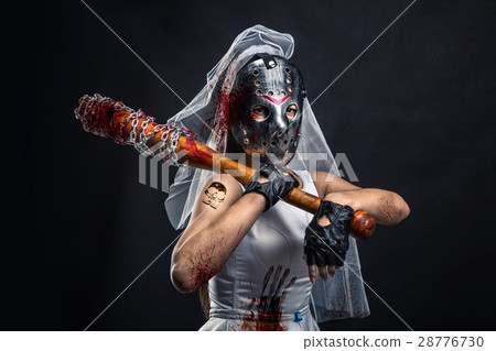Serial murederer in wedding dress with bloody bat 28776730