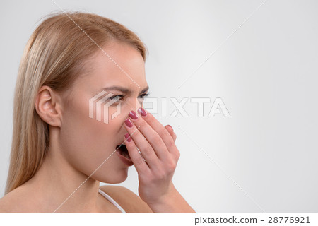 Young woman does not like her breath Young woman does not like her breath 28776921