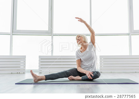 Joyful old woman undergoing morning exercises 28777565