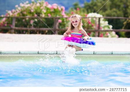 Child with toy ring in swimming pool Child with toy ring in swimming pool 28777715