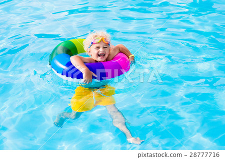 Child with toy ring in swimming pool Child with toy ring in swimming pool 28777716