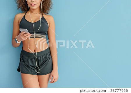 Active mulatto person listening to music 28777936