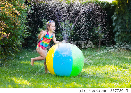 Little girl with toy ball garden sprinkler 28778045