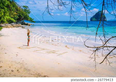 Women inscribed Help on the beach with waves and 28779413