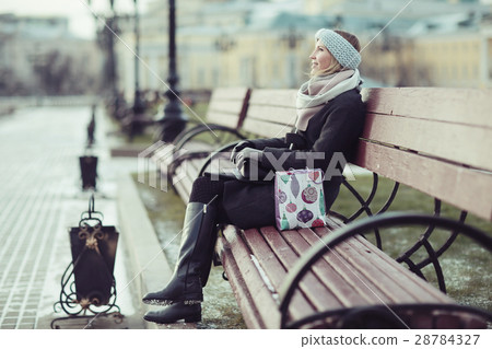 Dreaming woman in winter city a festive mood Dreaming woman in winter city a festive mood 28784327