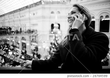 cheerful woman talking on the phone outside a city winter cheerful woman talking on the phone outside a city winter 28784599