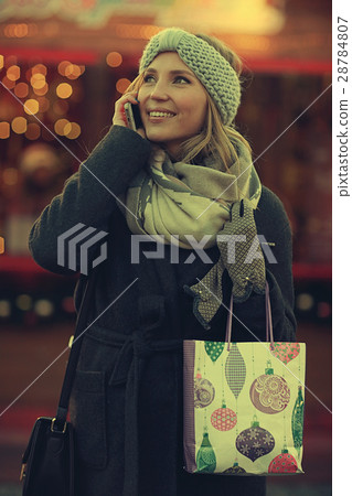 cheerful woman talking on the phone outside a city winter cheerful woman talking on the phone outside a city winter 28784807