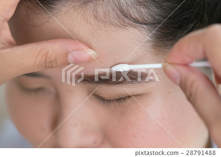 makeup with cotton brush on pretty woman face makeup with cotton brush on pretty woman face 28791488