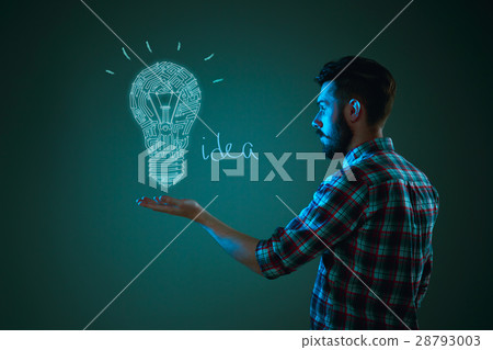 Handsome young man with idea bulb on blue 28793003
