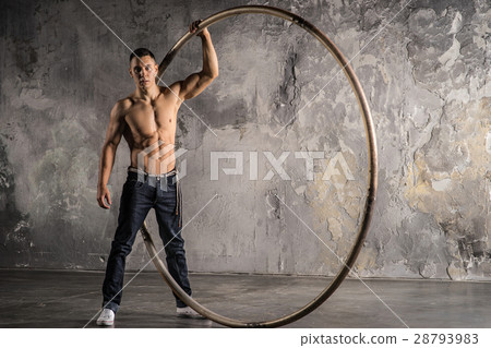 Circus artist in aCyr Wheel with strong muscles Circus artist in aCyr Wheel with strong muscles 28793983