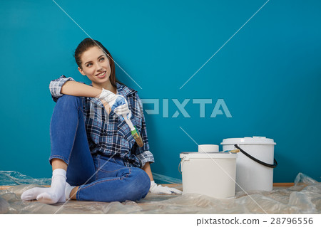 Happy beautiful young woman doing wall painting Happy beautiful young woman doing wall painting 28796556