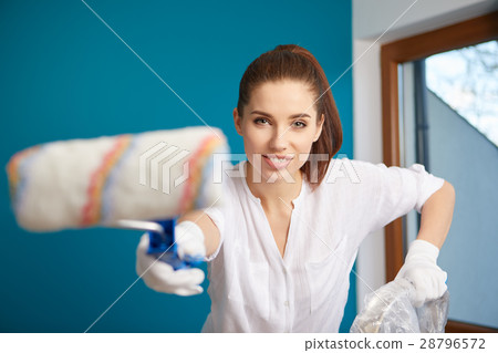 bright picture of lovely housewife painting  home 28796572