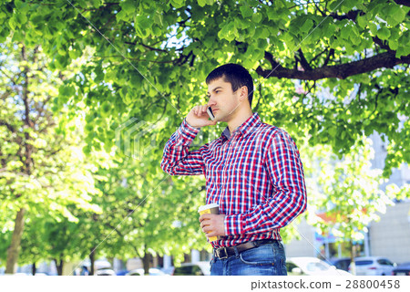 Man talking on the phone, in the summer in the Man talking on the phone, in the summer in the 28800458