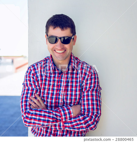 A man stands in the city of a white wall, summer A man stands in the city of a white wall, summer 28800465