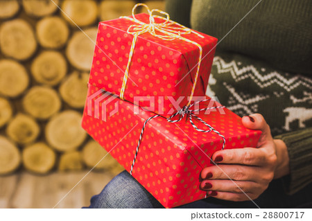 Close up of female hands with small red gift boxes Close up of female hands with small red gift boxes 28800717