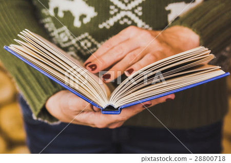 adult woman holding blue book 28800718