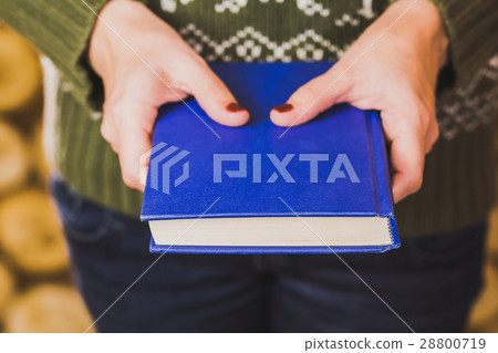 adult woman holding blue book adult woman holding blue book 28800719