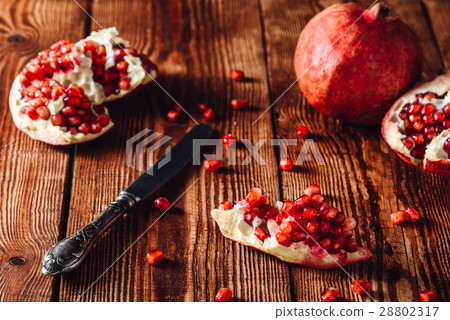 Opened Pomegranate Fruit and Knife Opened Pomegranate Fruit and Knife 28802317