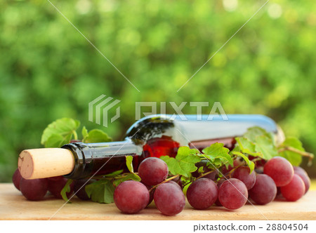 Wine bottle, red grape and green leaves Wine bottle, red grape and green leaves 28804504