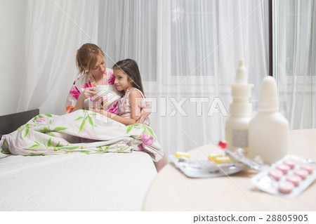 mother embraces the sick child. sore throat, flu 28805905