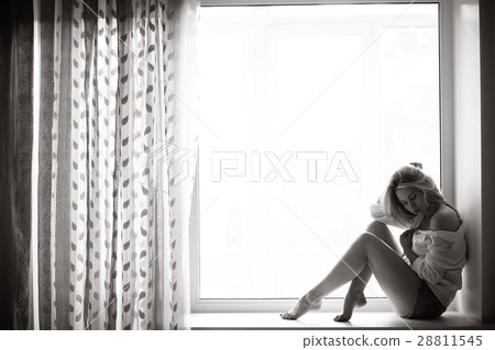 beautiful girl lying at home on a window 28811545