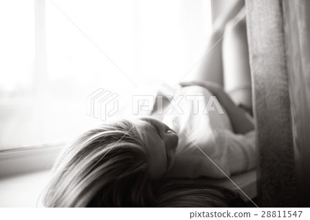 beautiful girl lying at home on a window 28811547