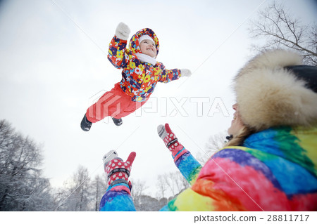 small child and young mother in the winter outside in warm clothes fun 28811717