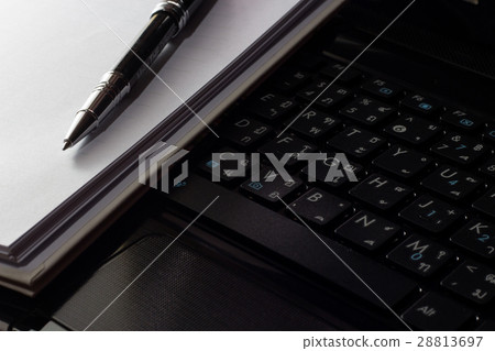 close up laptop and pen on notebook 28813697