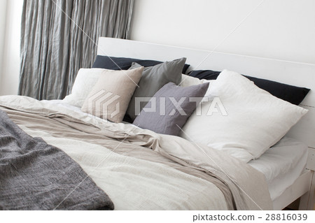 Bed with white and grey linens Bed with white and grey linens 28816039