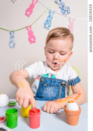 smilling boy making bunny for easter smilling boy making bunny for easter 28816429