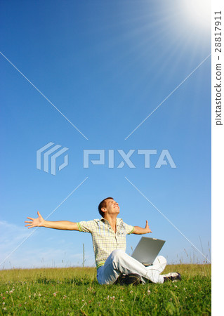 Student with laptop on green meadow Student with laptop on green meadow 28817911