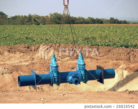 Crane handling 500mm pipe with gate valves 28818542