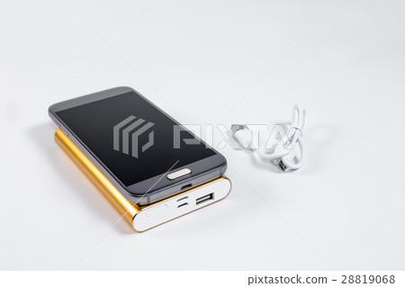 Golden powerbank with smart phone on background 28819068