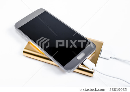 Golden powerbank with smart phone on background 28819085