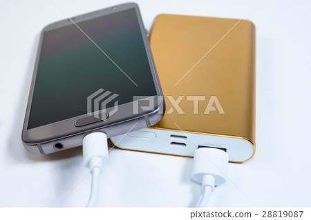 Golden powerbank with smart phone on background 28819087