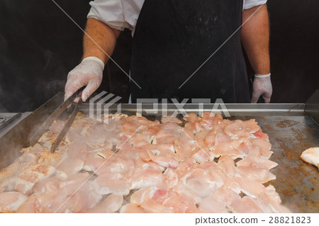 Hands of man take cooking of chicken meat Hands of man take cooking of chicken meat 28821823