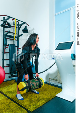 The female athlete doing they exercise in a ems The female athlete doing they exercise in a ems 28821937