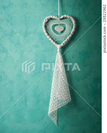 White dream catcher on green wall White dream catcher on green wall 28822962
