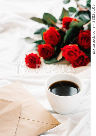 cup of coffee and a bouquet of red roses, envelope cup of coffee and a bouquet of red roses, envelope 28823109
