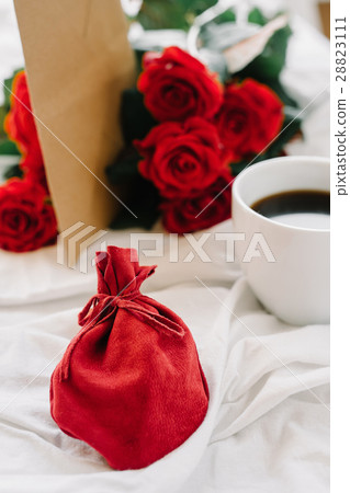 cup of coffee and a bouquet of red roses, envelope cup of coffee and a bouquet of red roses, envelope 28823111