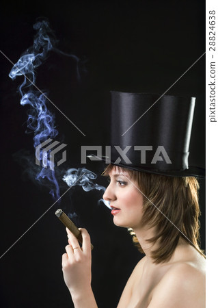 backlight picture of topless brunette smoking cigar 28824638