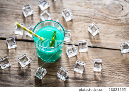 Glass of blue curacao and juice cocktail Glass of blue curacao and juice cocktail 28825365