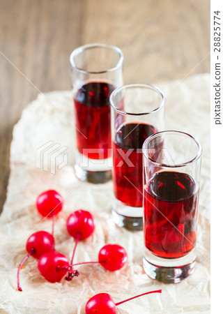 Glasses of cherry brandy with cocktail cherries 28825774