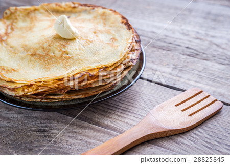 Pile of crepes on the wooden table 28825845