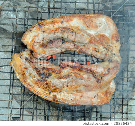Grilled pork over flames on the grill. Grilled pork over flames on the grill. 28826424