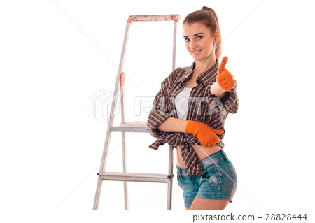 young beautiful girl stands near ladder for repair 28828444